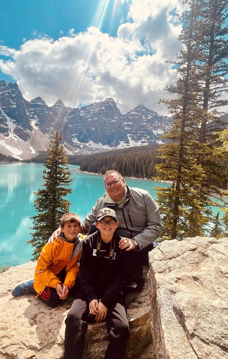 A Family Enjoying Scenic View at Mountain Lake