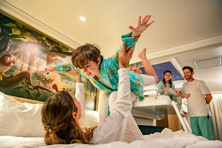 Family enjoying one of the comfortable staterooms on a Disney cruise.