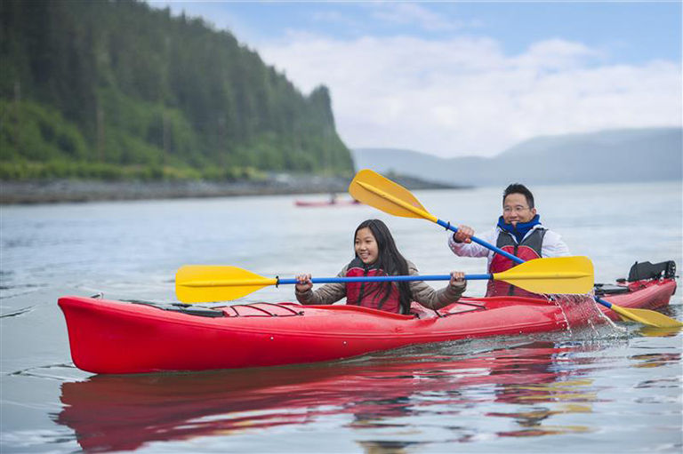 Disney Cruise Line guests kayaking in Alaska.