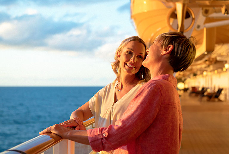 Disney Cruise Line guests take in the serene view at sunset.