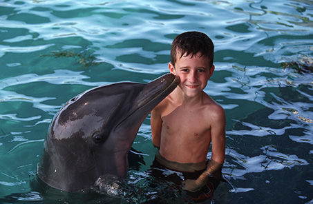 Disney Cruise Line Nassau Bahamas child with dolphin