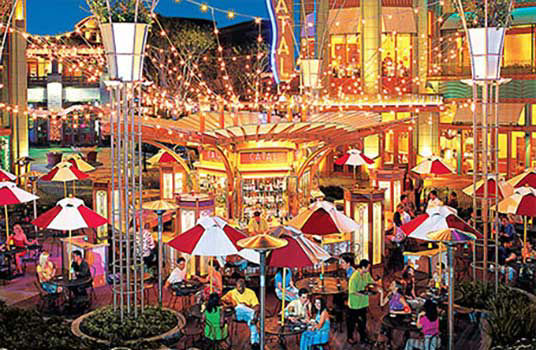 Group of people dine and walking around disneyland's downtown district.