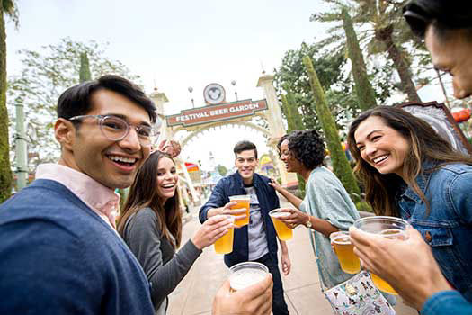 Group of friends are grabbing beers and laughing together.