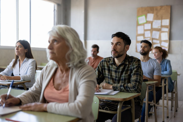 Group of Latin American college students of all ages paying attention in class -education concepts