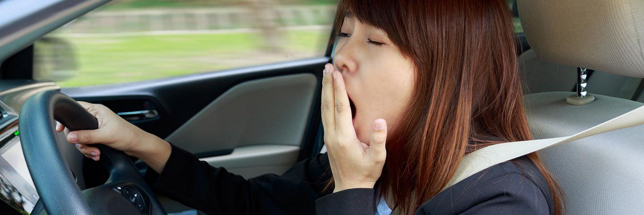 Drowsy driver yawning while driving