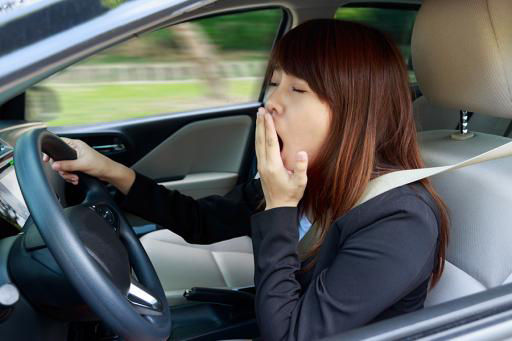 Drowsy driver yawning while driving