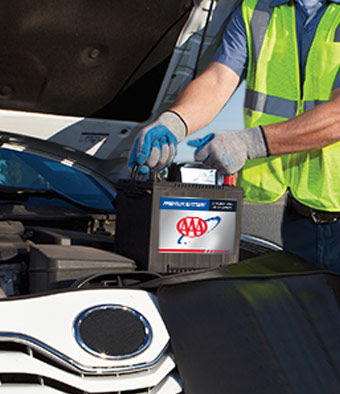 Technician putting in a car battery.