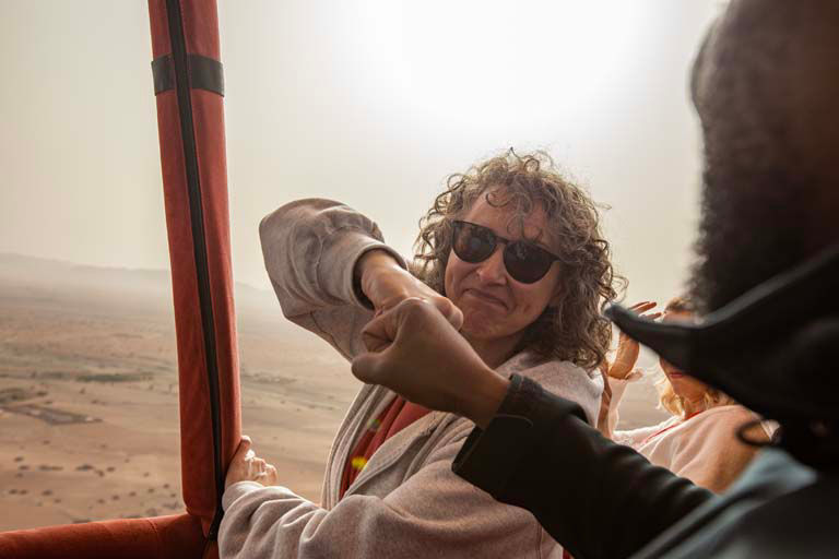 Traveler with sunglasses enjoying a hot air balloon ride over the Moroccan desert near Marrakech