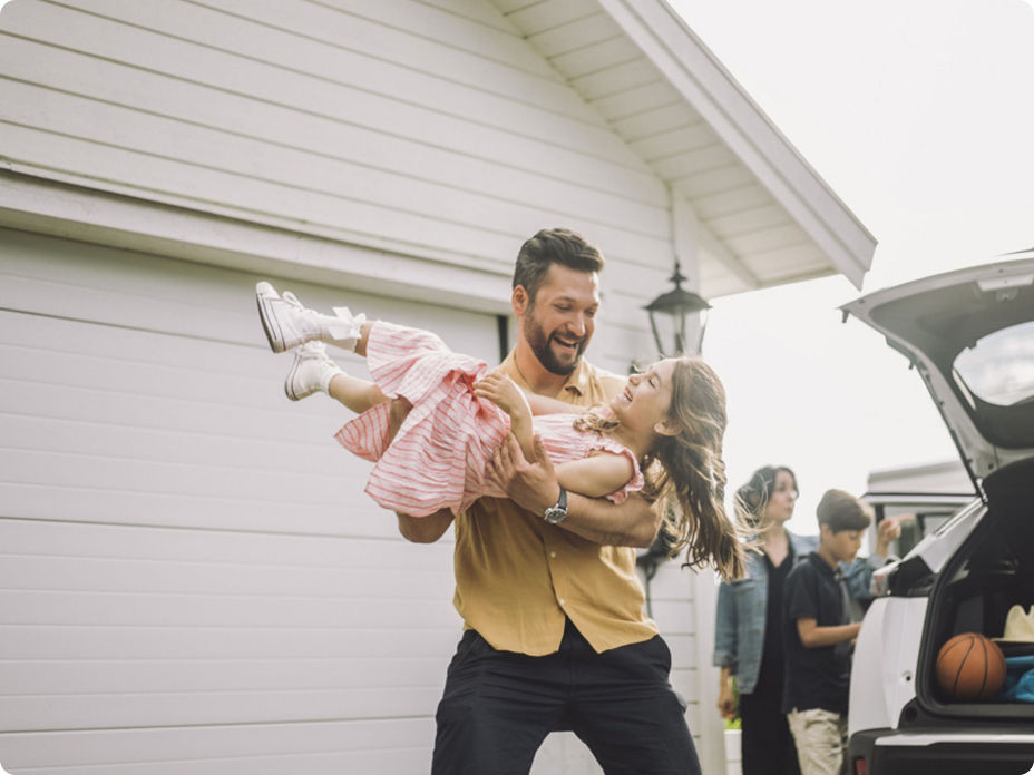 Man carrying daughter happily.