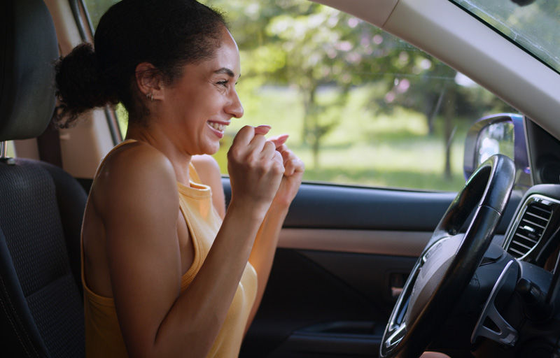 Woman in car excited