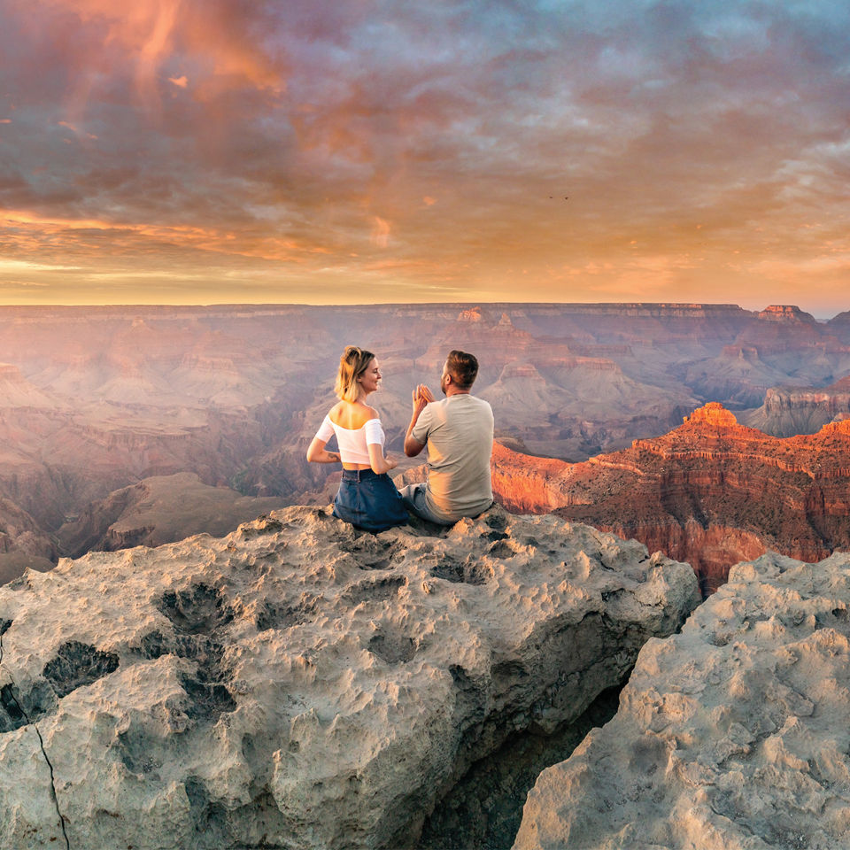Couple enjoying the sunset at the Grand Canyon.