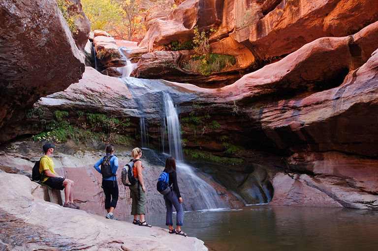 2007, dusk, Zion National Park. Hikers inside a walled canyon admiring the view.