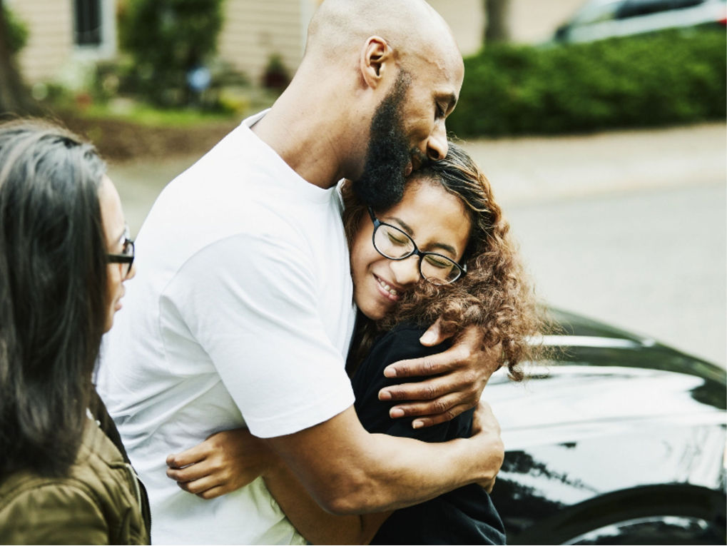 Father hugging his daughter.