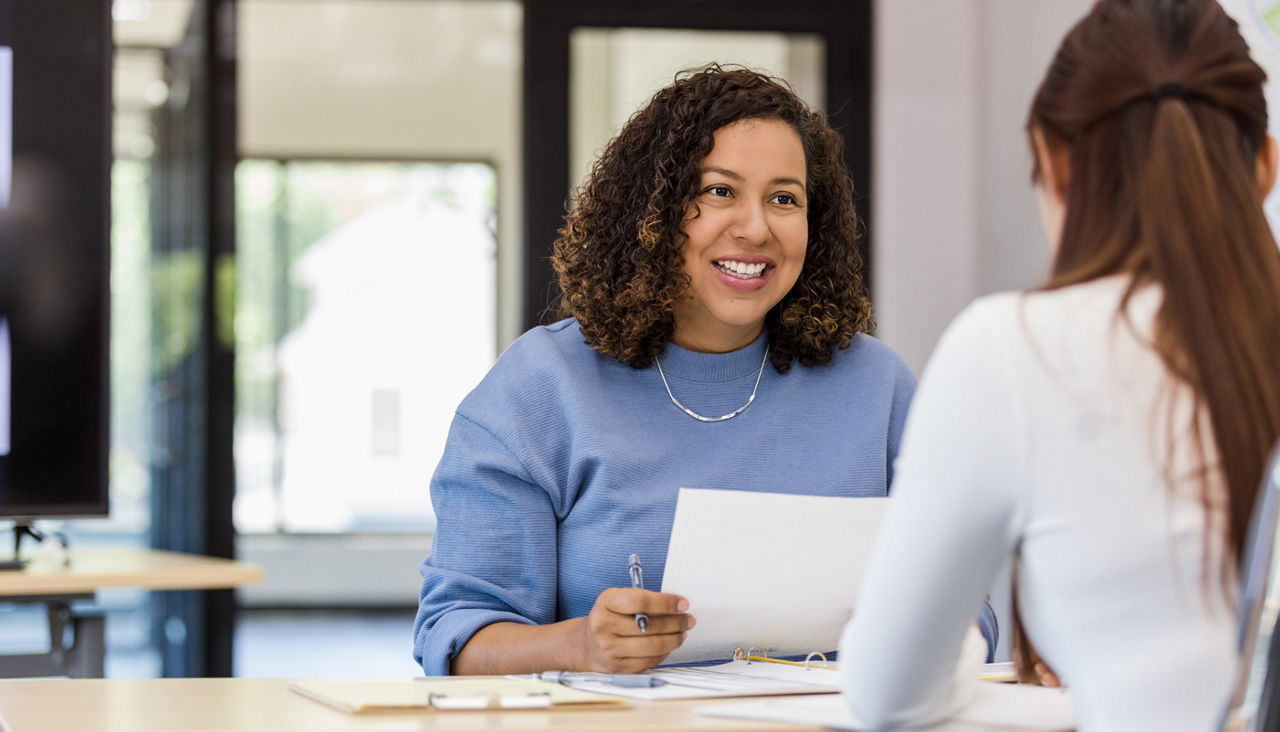 woman at desk with papers