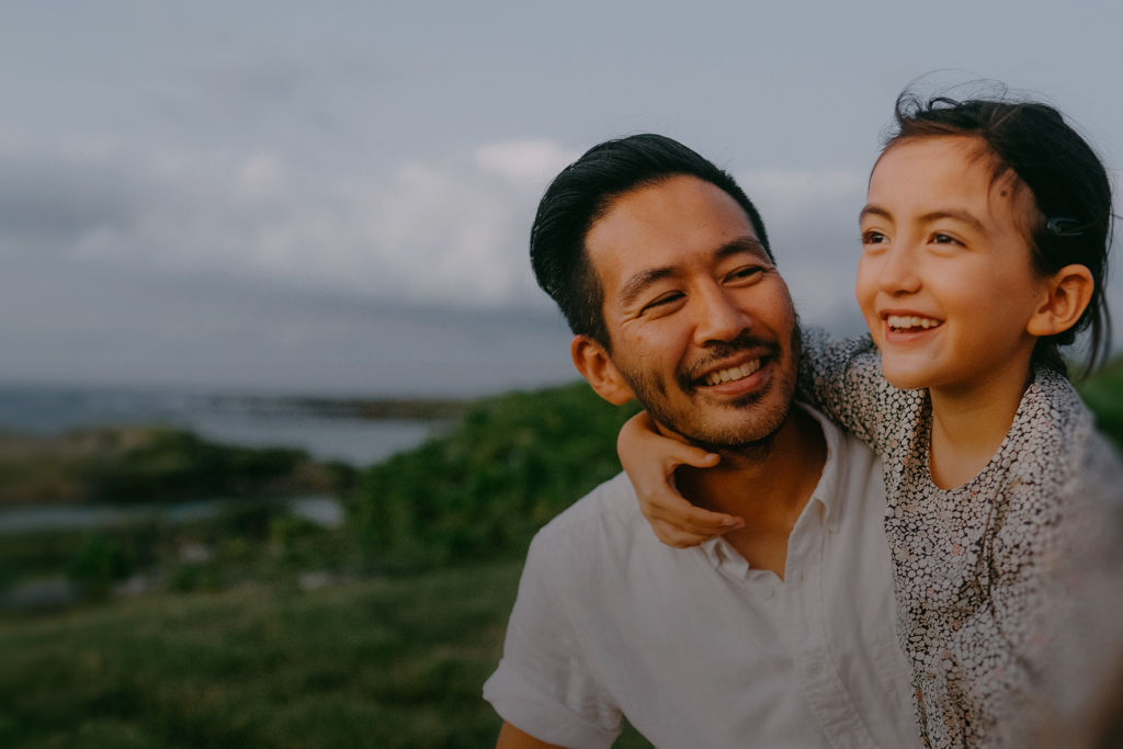 an older man and his grandchildren hugging.