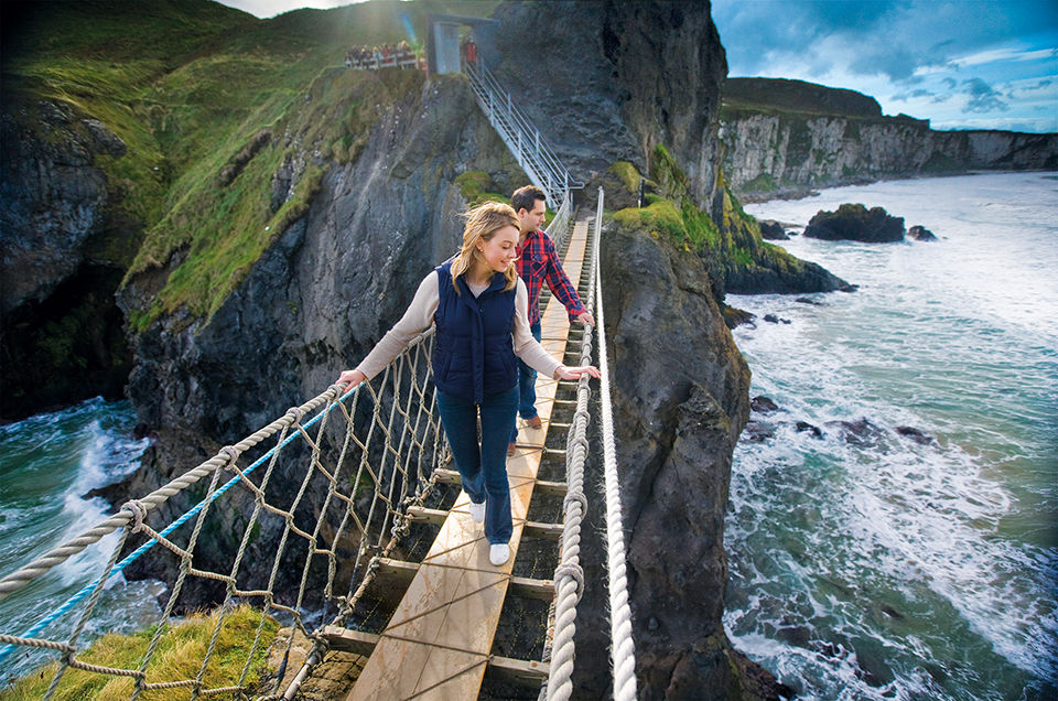 Couple on a tour from AAA Travel, walking on a bridge.