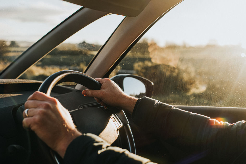 Hands on steering wheel.