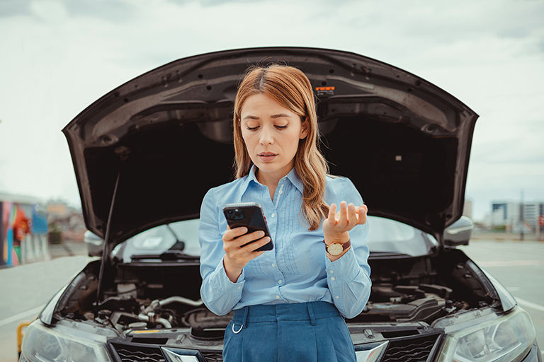 Woman on phone after car accident filing an insurance claim