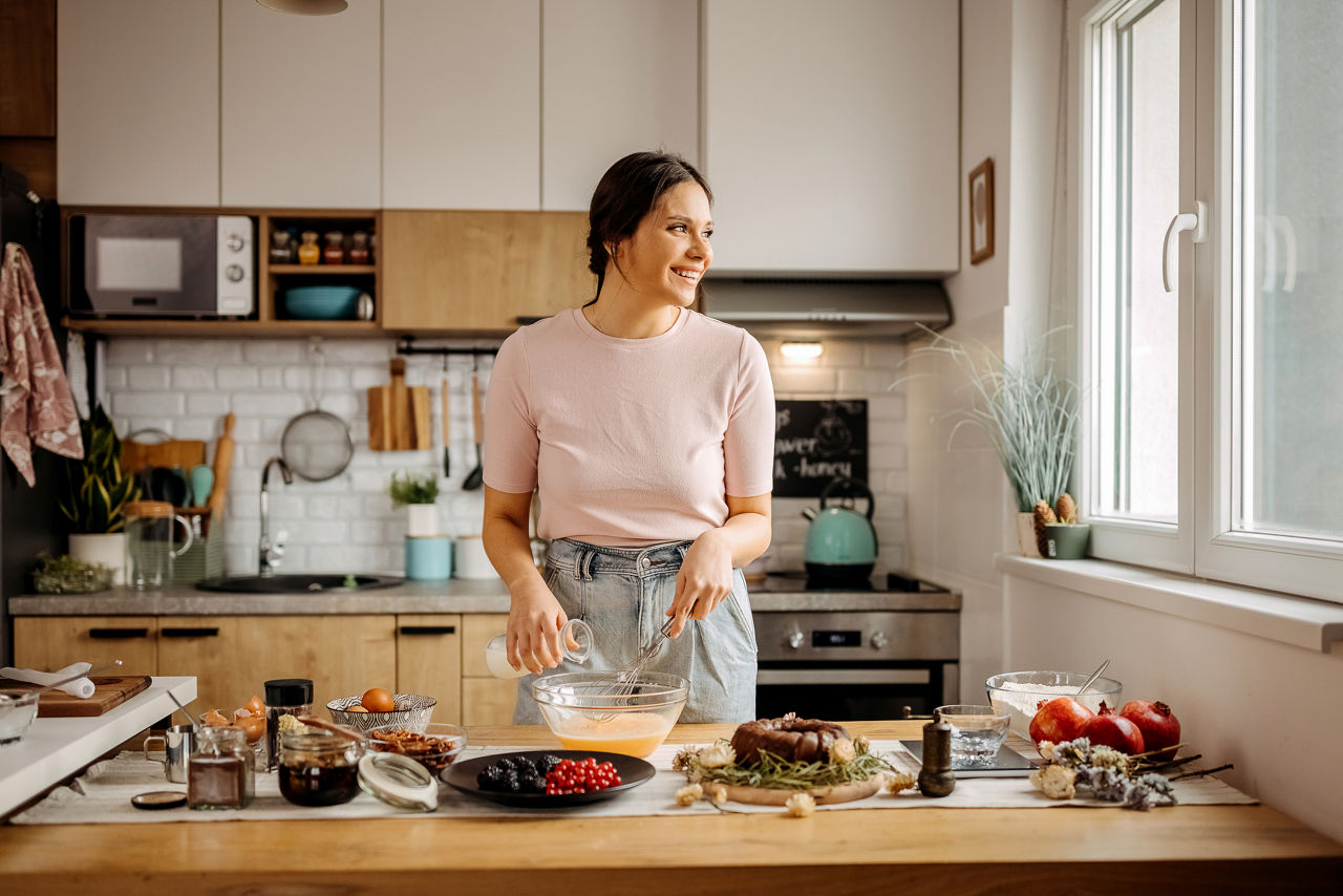woman in kitchen making food