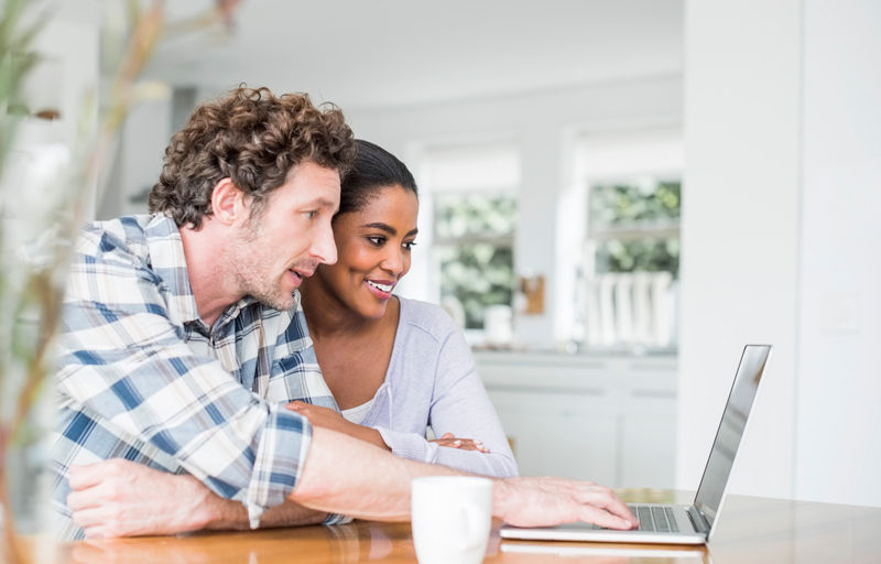 Couple viewing laptop for money management