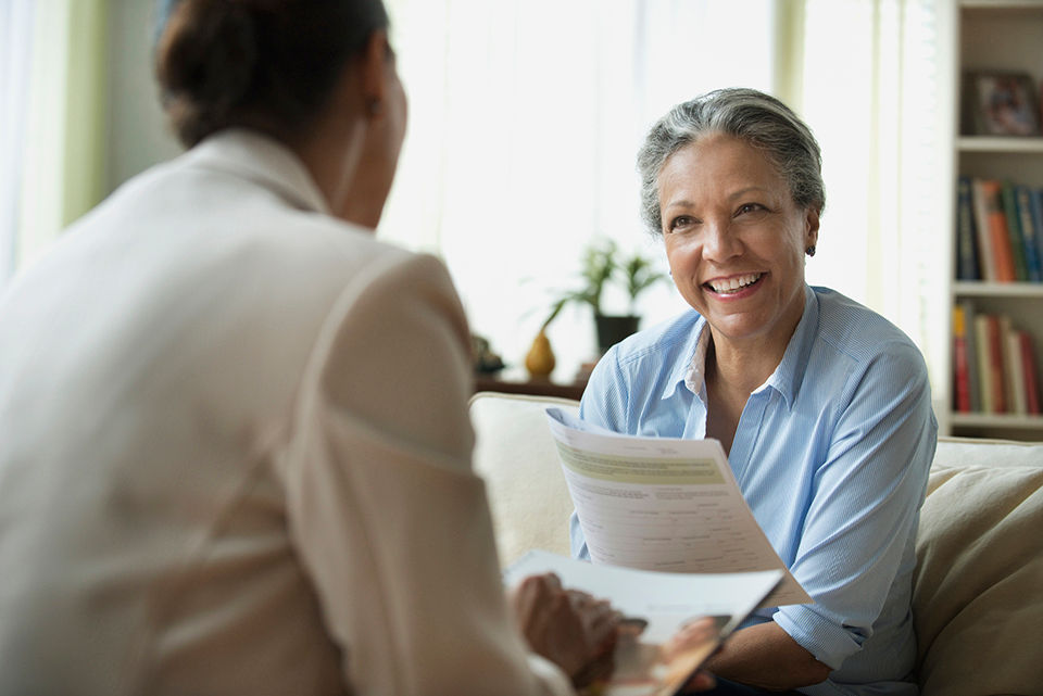 Women looking over paperwork in living room