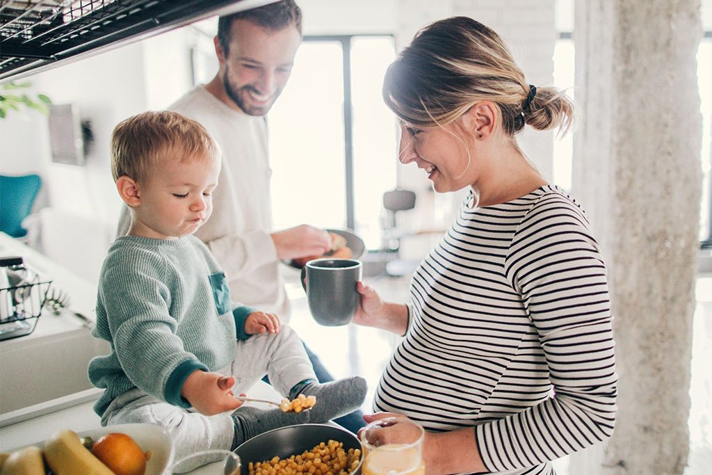 Family making breakfast together in kitchen