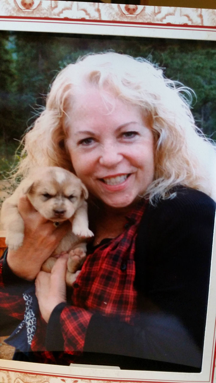 Woman holding a puppy.