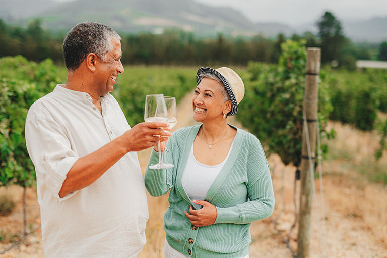 Mature couple, wine tasting in a luxurious estate, while bonding in nature