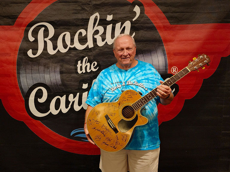 Fan holding a guitar