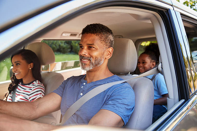 Family In Car Going On Road Trip