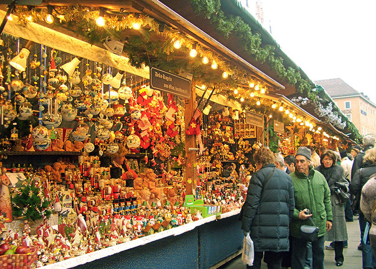 Shoppers at a stall in a European Christmas market.