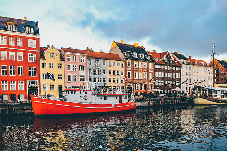 View across the canal of colorful row houses in Scandinavia.