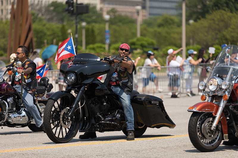 Chicago, Illinois, USA - June 16, 2018: The Puerto Rican Day Parade, Puerto rican bikers riding motorcycles with the puerto rican flag during the parade