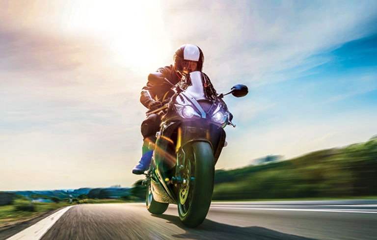 Dynamic shot of a man riding his motorcycle.