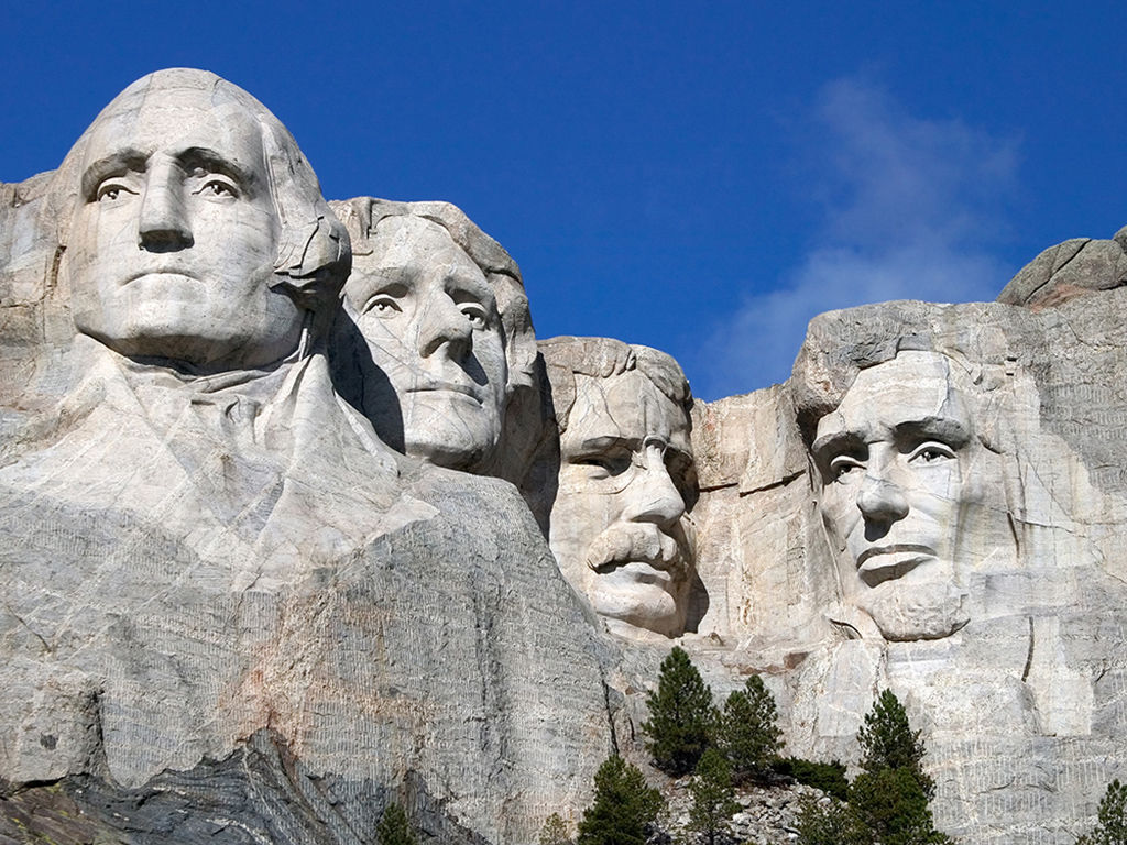 Close up view of Mount Rushmore under a blue sky