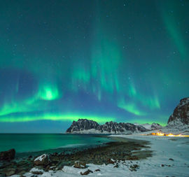 aurora borealis shining over the beach