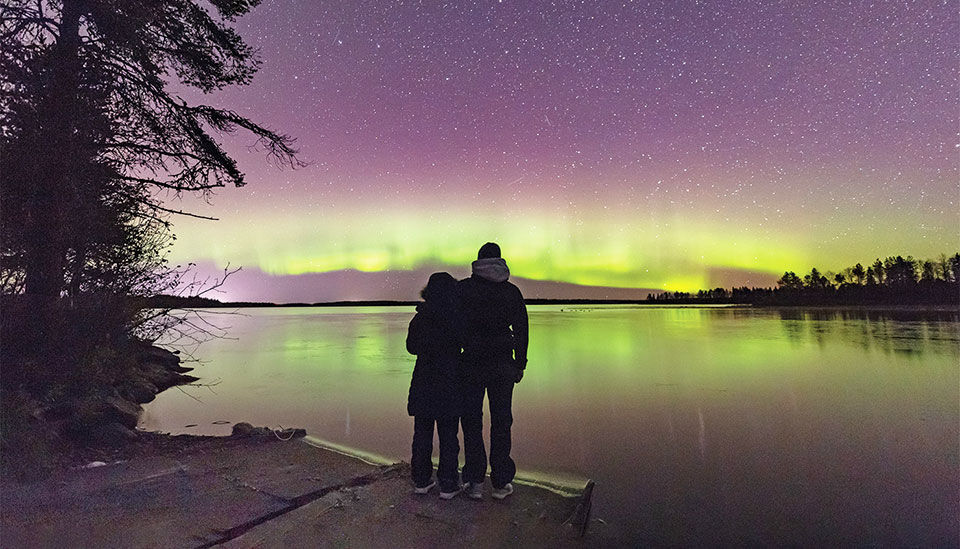Norway expeditions. A couple admiring the northern lights.