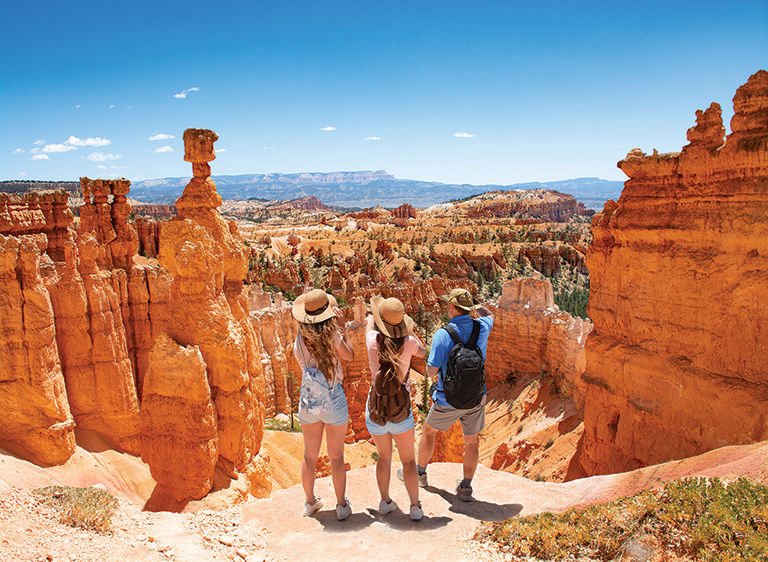 Family standing next to Thor's Hammer looking at beautiful view.