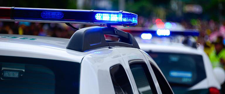Police cars and officers talking to impaired driver