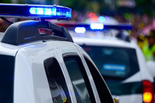 Police cars and officers talking to impaired driver