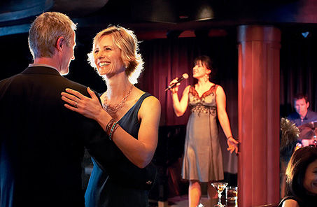 Couple dancing in a lounge with live music aboard Princess Cruises.