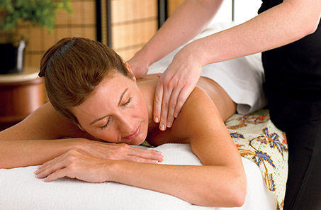 Woman getting a relaxing massage at the Lotus Spa aboard Princess Cruises.