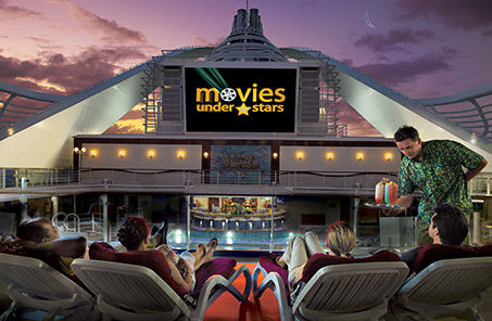 Movies under the stars on the pool deck with server bringing drinks on Princess Cruises.