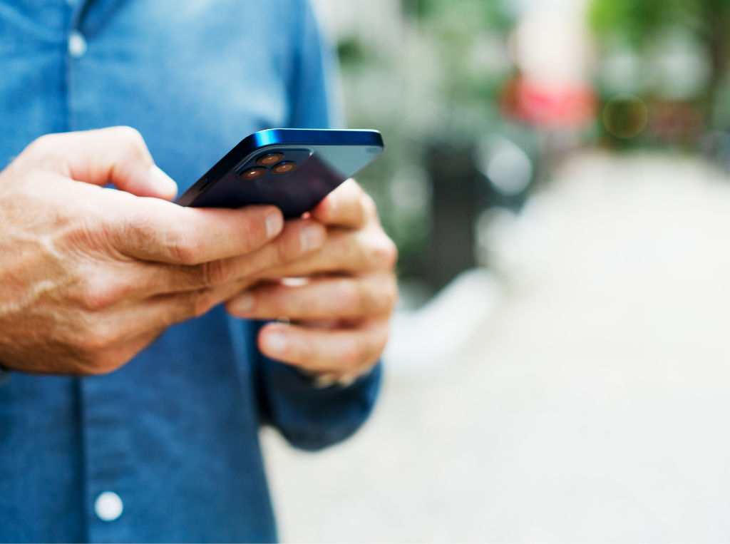 Man outside on his phone. 