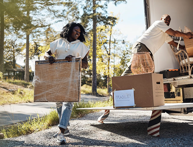 Couple unpacking a moving truck.