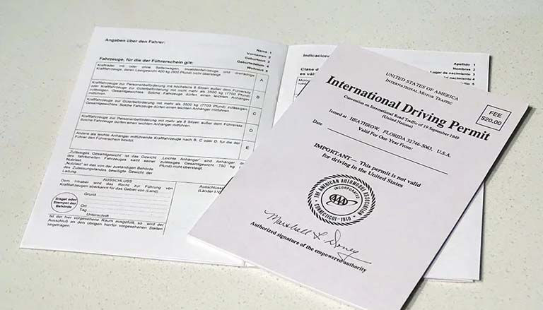An International Driving Permit lying on a light-colored surface.