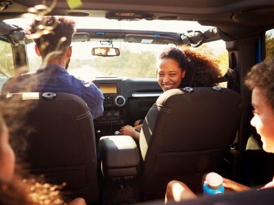 A family is in the car on a fun road trip together