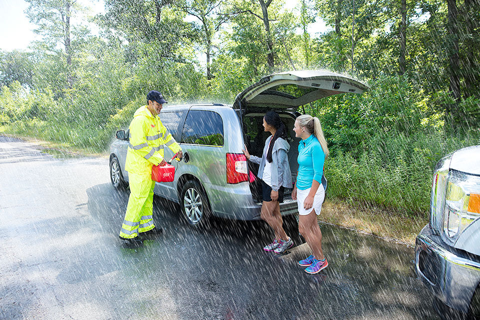 Two women are getting roadside help using AAA. 