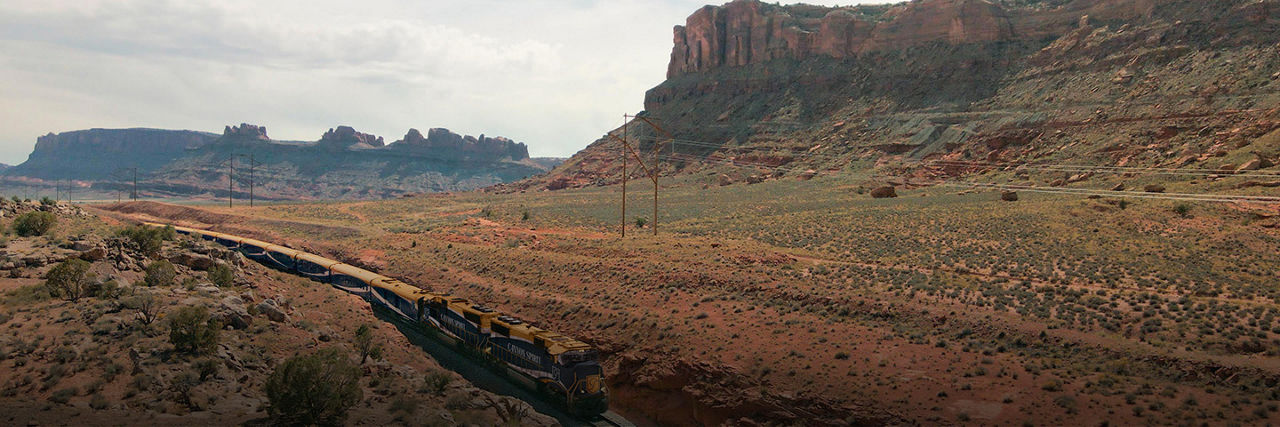 Train traveling Rocky Mountains to Red Rocks