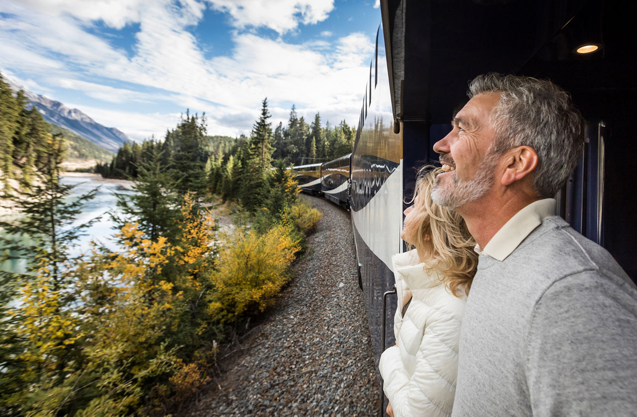 Couple looking out of the window on the Rocky Mountaineer  vacation.